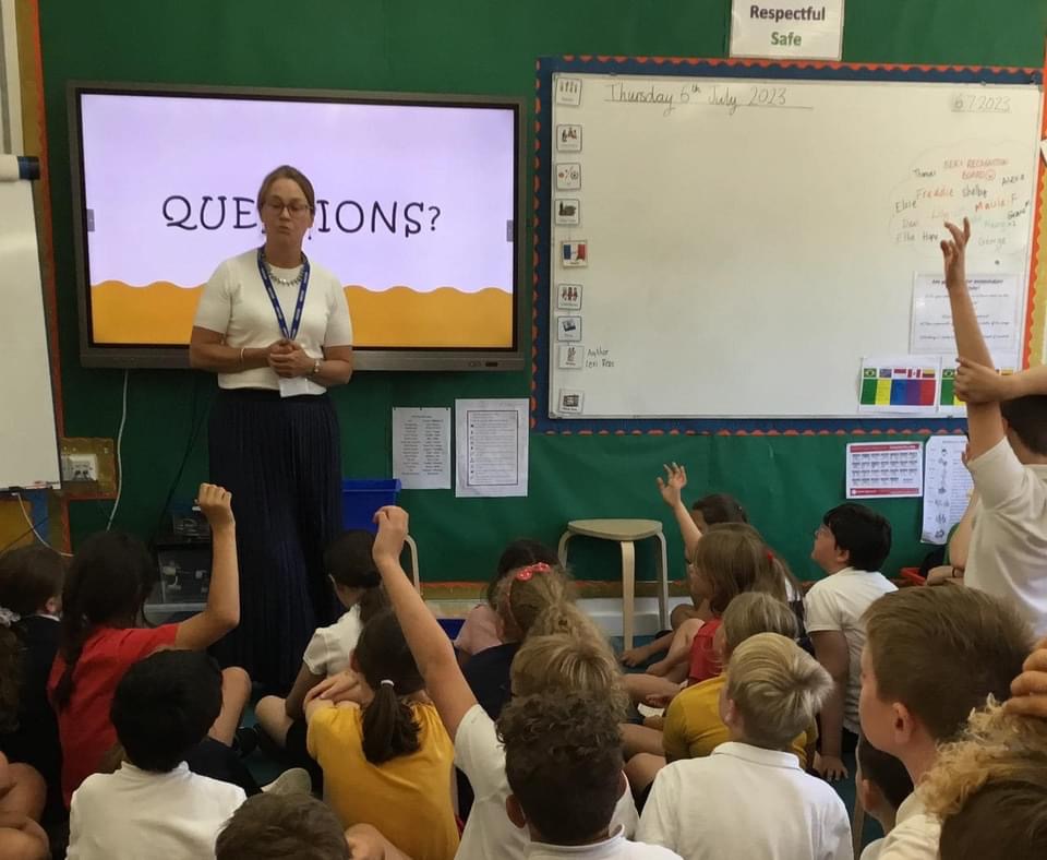 Lexi Rees taking student questions from a highly engaged class