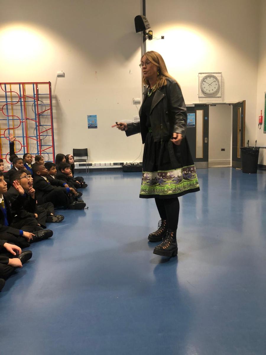 Lexi Rees holding an assembly at Oasis Hadley Primary School in London
